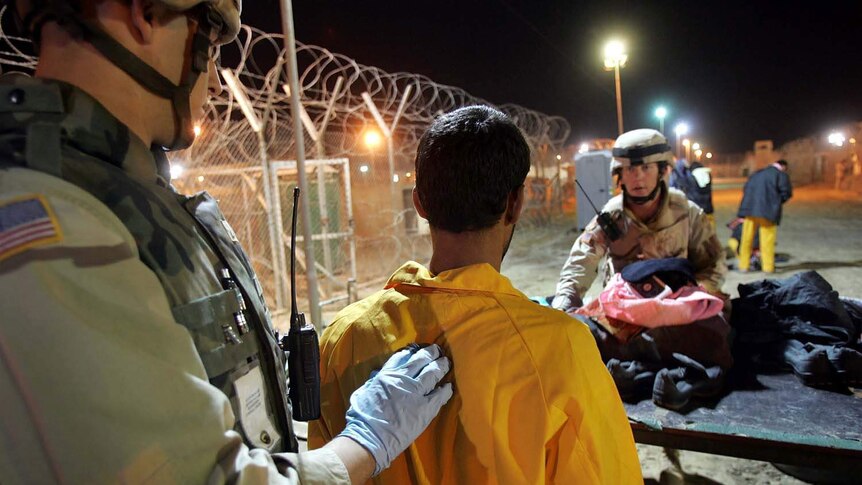 US army military policeman process new detainees at the Abu Ghraib prison