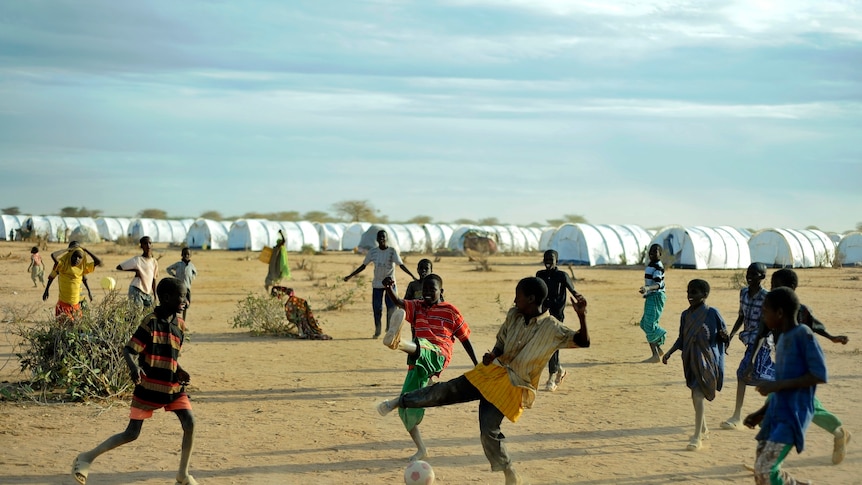 Young Somali refugees play football at the Ifo extension to the Dadaab refugee camp