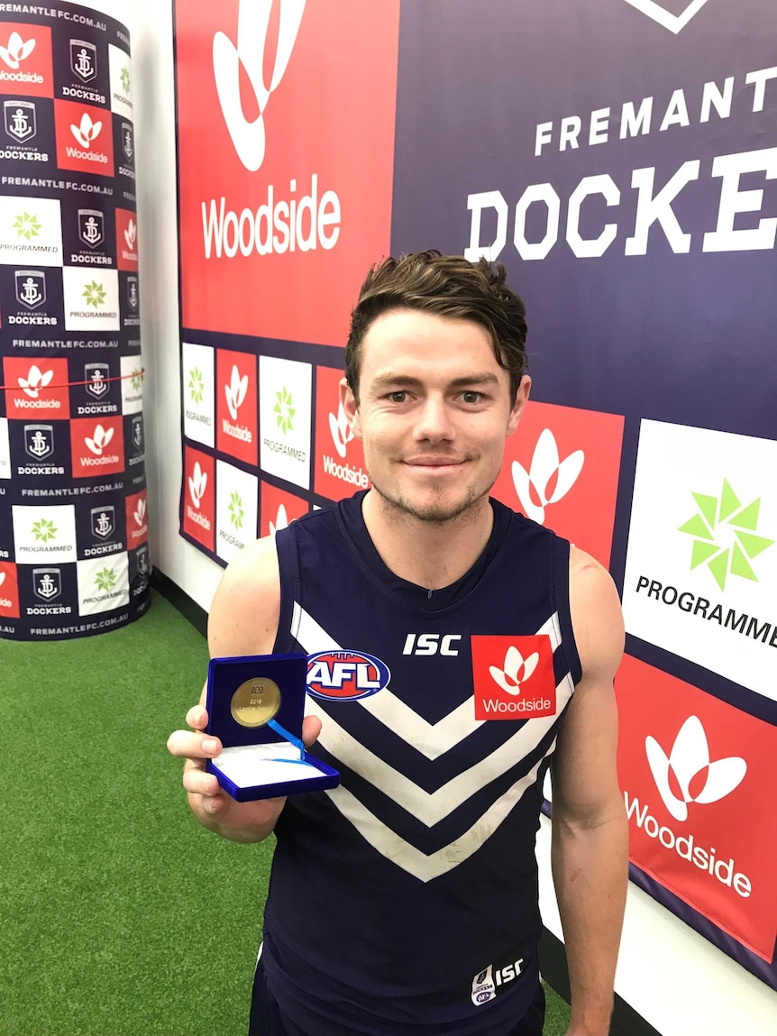 Lachie Neale with the Geoff Christian Medal after winning the award for the 2018 AFL season.