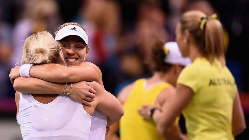 Angelique Kerber of Germany celebrates with team captain Barbara Rittner after her single match against Samantha Stosur