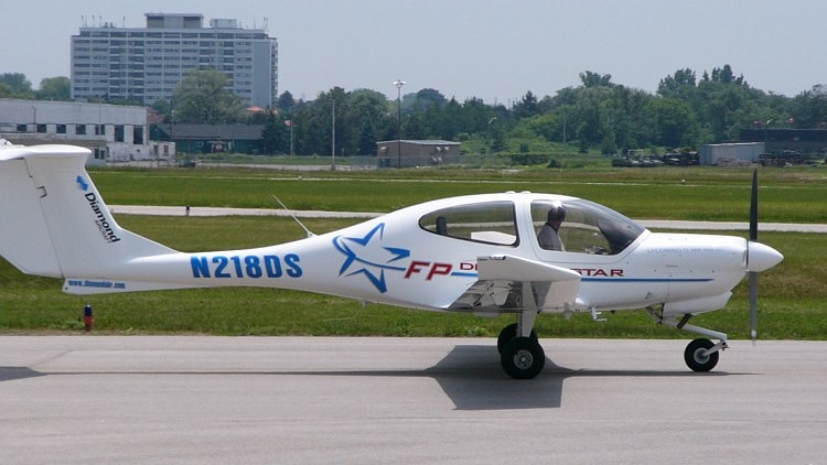 A small white aeroplane at an airport.