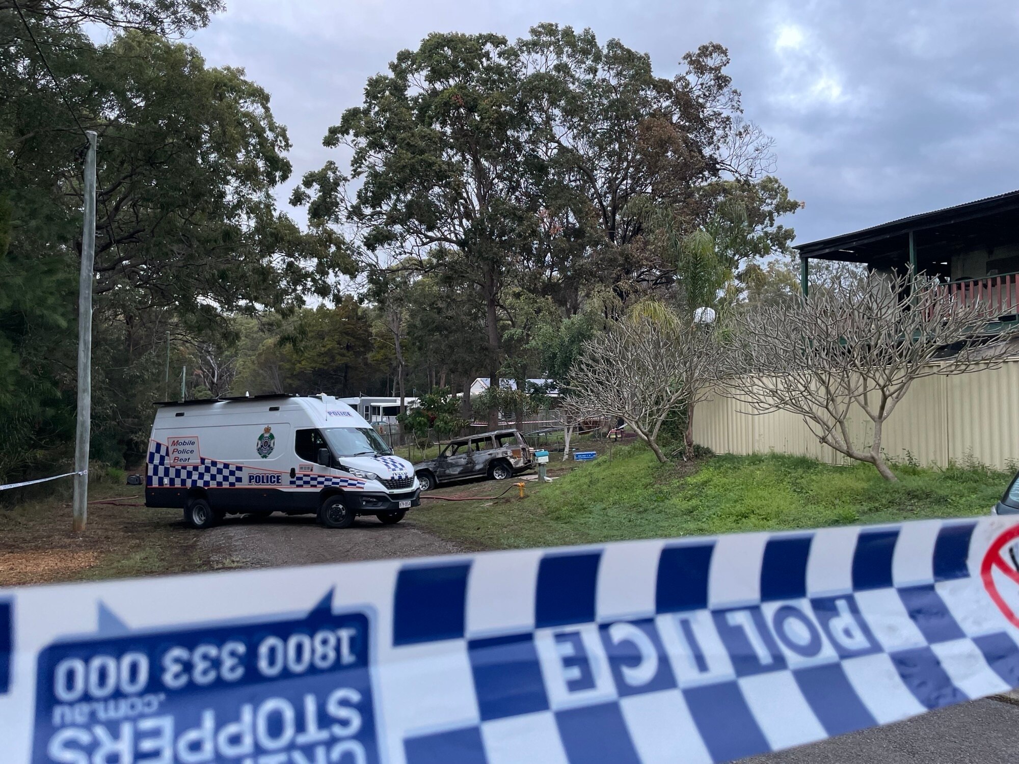 A police exclusion zone following a fatal house fire on Russell Island