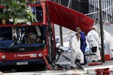 Forensic investigators examine the remains of the bombed-out bus in Tavistock Square