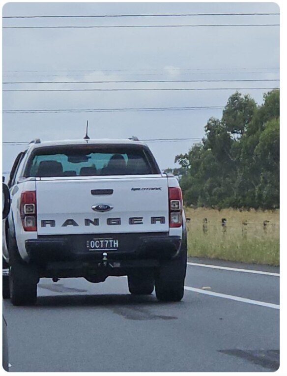 the back of a white ute with oct7th number plate