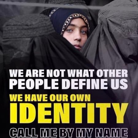A poster shows a girl staring through a sea of burkas with the words, "We are not what others define us".