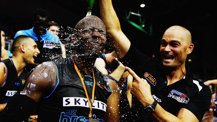 Winners are grinners ... Breakers assistant coach Judd Flavell pours champagne on Cedric Jackson