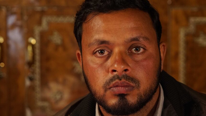 A closeup photo of Farooq Dar looking into the camera.