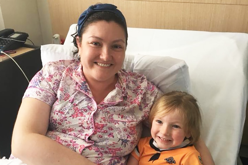 Rebecca Tucker and her daughter in a hospital bed