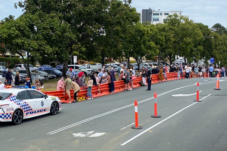 Families gather on either side of the Qld-NSW border in Coolangatta.