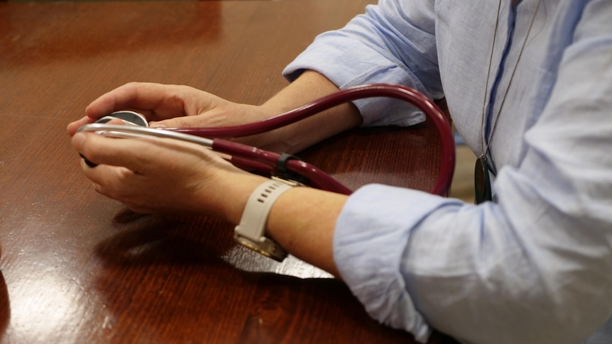 A pair of hangs holding a stethoscope