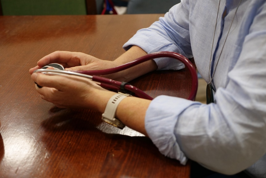 A pair of hangs holding a stethoscope