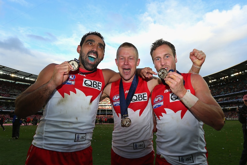 Bleed red and white: Norm Smith medallist Ryan O'Keefe celebrated with fellow dual-premiership winners Adam Goodes and Jude Bolton.