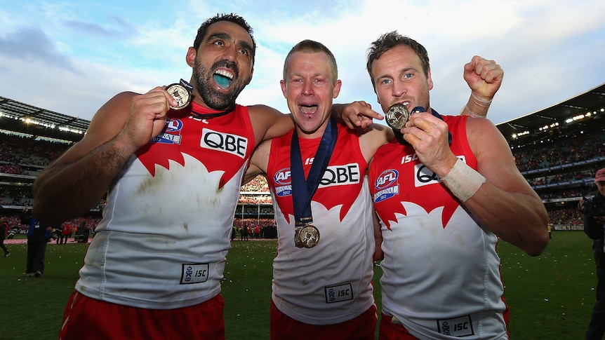 Bleed red and white: Norm Smith medallist Ryan O'Keefe celebrated with fellow dual-premiership winners Adam Goodes and Jude Bolton.