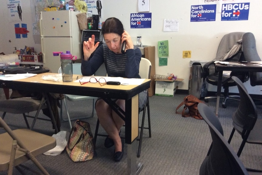 Kathleen Reardon sits at a desk talking on the phone in the campaign office