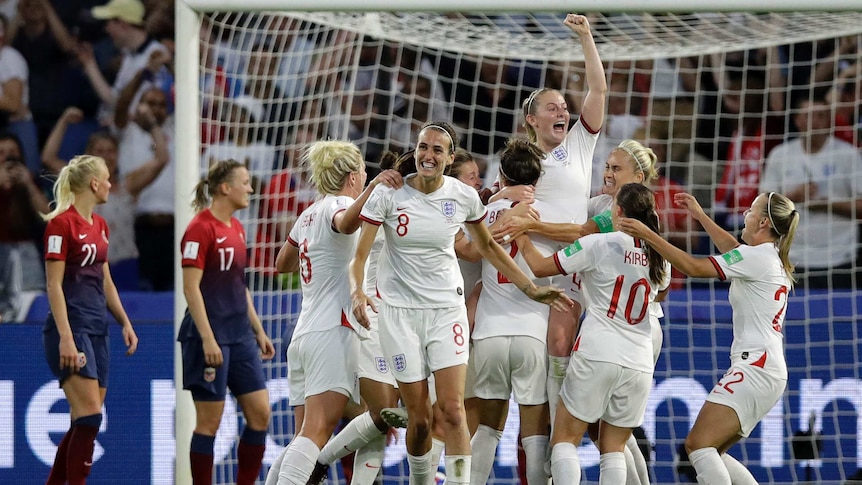 England players in white shirts jump together and celebrate