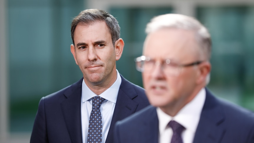 Chalmers standing behind his leader, Albanese out of focus speaking in foreground.