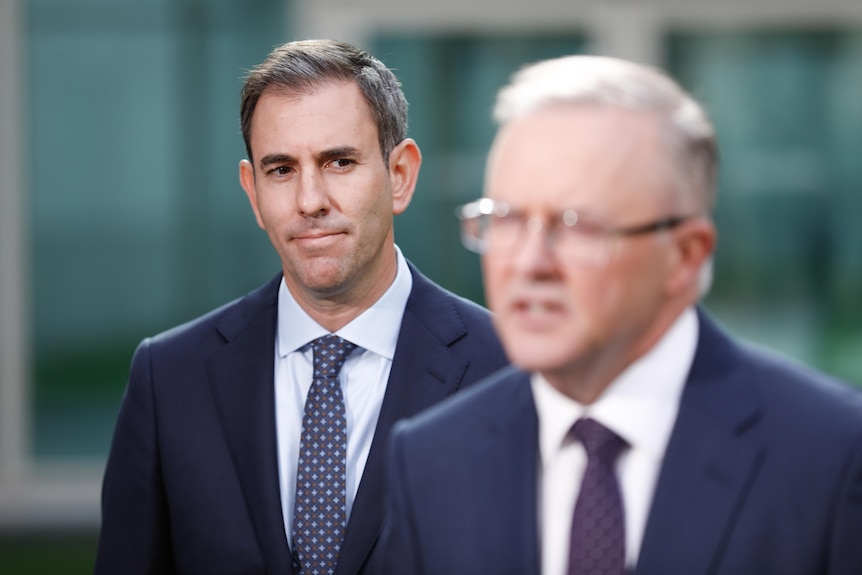 Chalmers standing behind his leader, Albanese out of focus speaking in foreground.