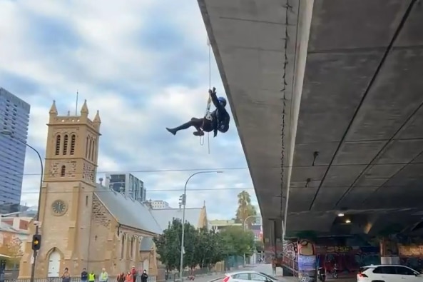 A person abseiling from a bridge