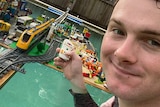 Young man in pool with Lego set