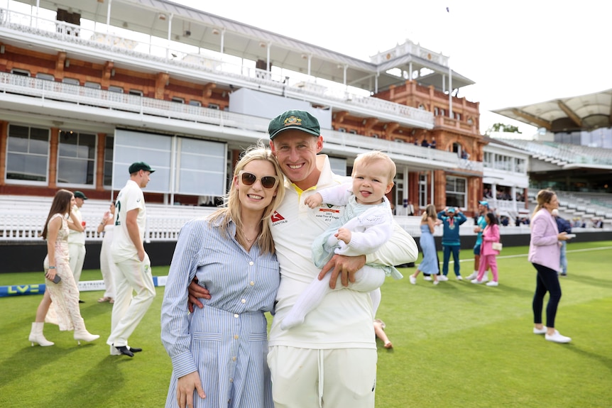 Rebekah and Marnus Labushagne hug as they get a photo with their daughter