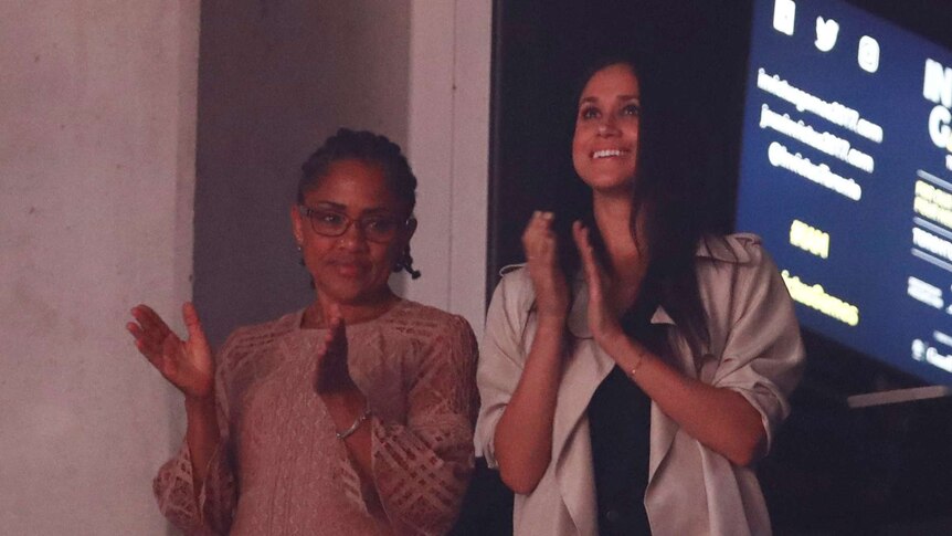 Meghan Markle and her mother Doria Ragland are clapping while standing