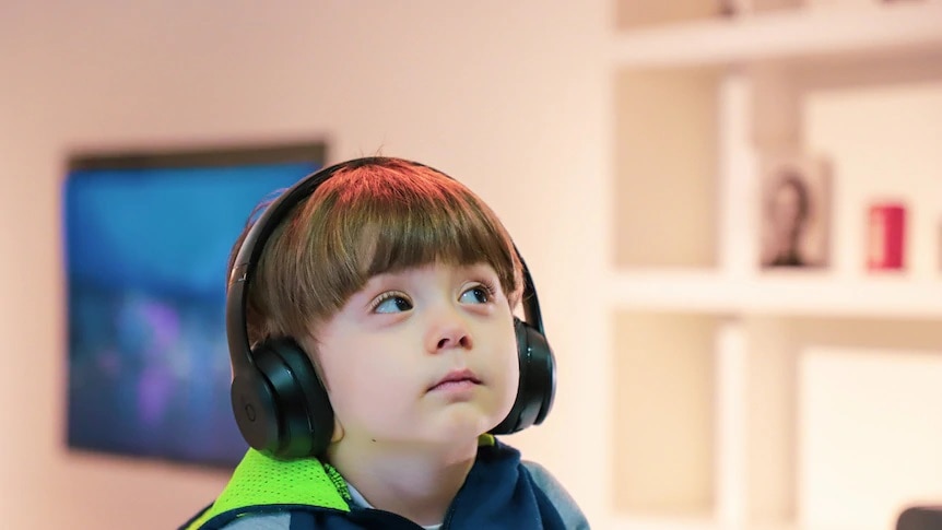 Child listening with headphones on.