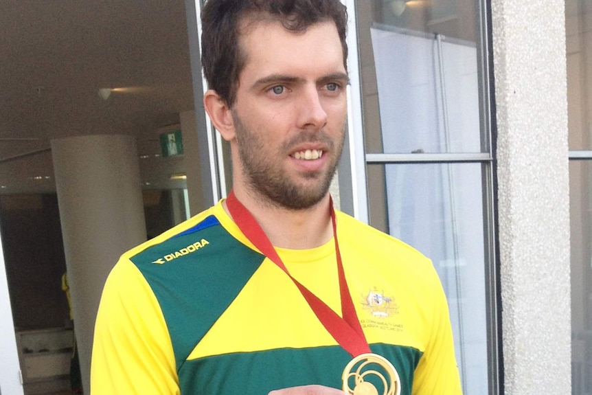 Kookaburras goalkeeper Andrew Charter displays his Commonwealth Games gold medal.