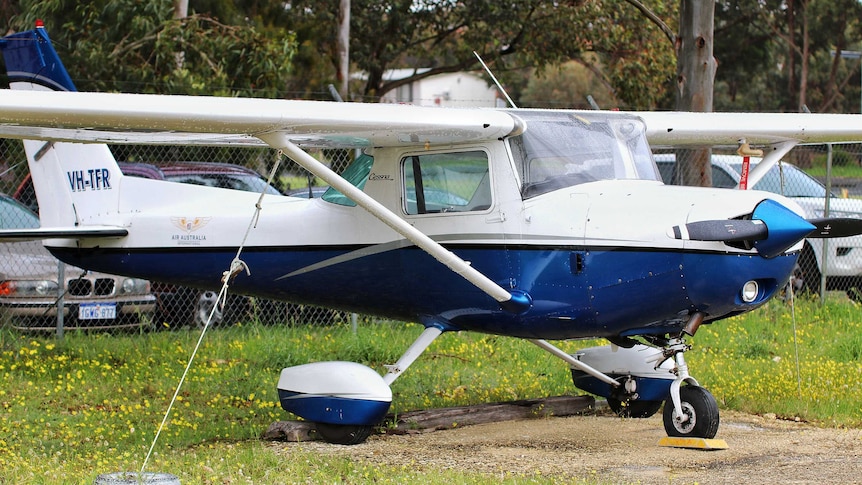 A light aircraft parked on grass