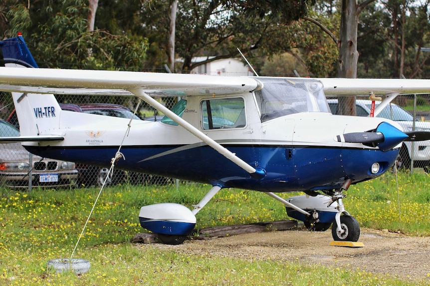 A light aircraft parked on grass