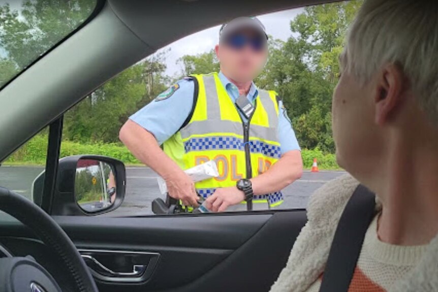 A police officer stops NSW MP Cate Faehrmann for a roadside drug test.