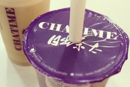 A close up image of drinks from Chatime, with a purple lid. 