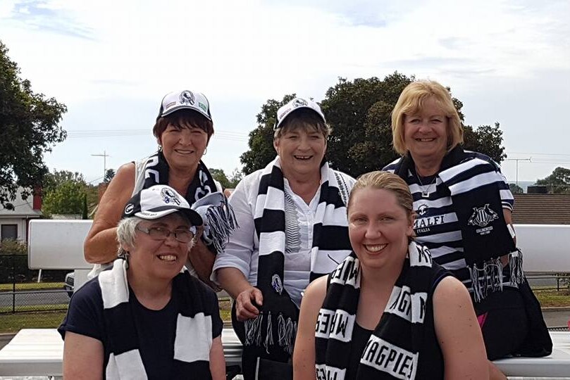 Women in black and white sport gear cheer