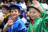 Two young boys dressed in jockey outfits enjoying the Melbourne Cup parade