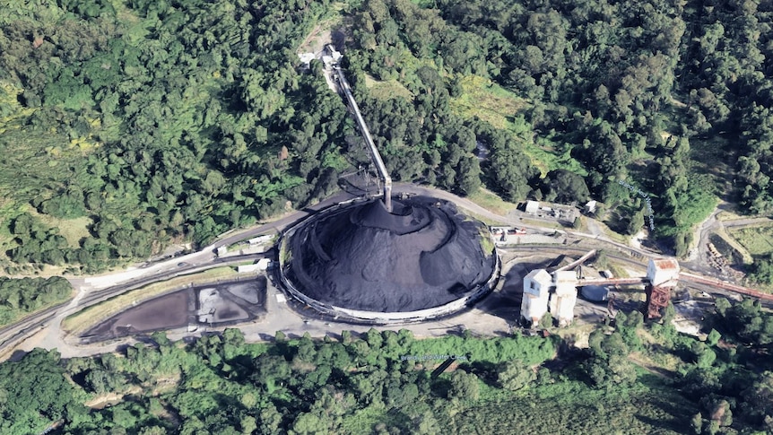Aerial view of a coal mine with a pile of black coal.
