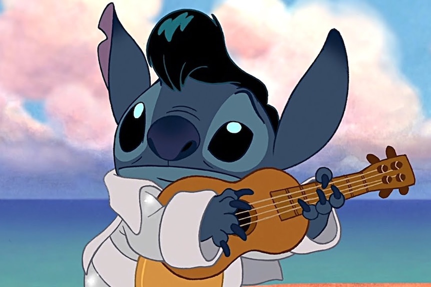 Screengrab of Stitch dressed as Elvis with a ukelele against a pristine ocean background and dreamy pink clouds.