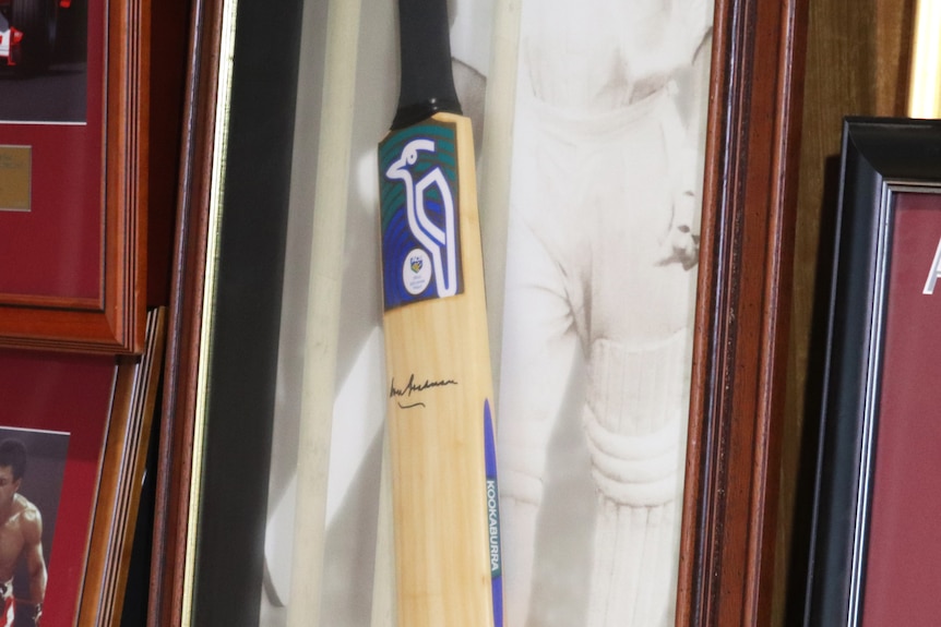 Signed cricket bat of Don Bradman in a boxed frame