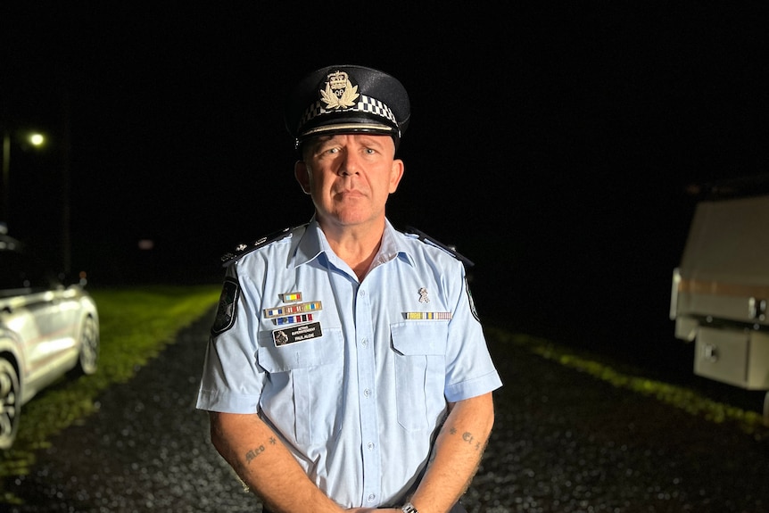 Acting Superintendent Paul Algie standing on a rural road at night