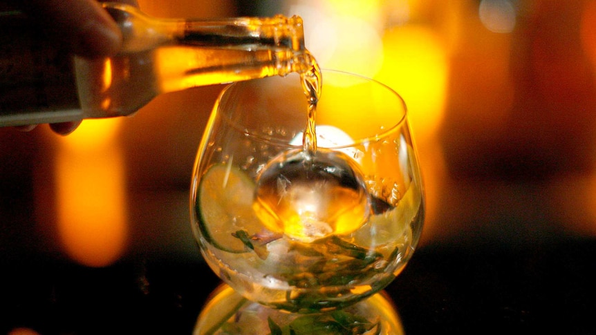 A gin glass being filled.