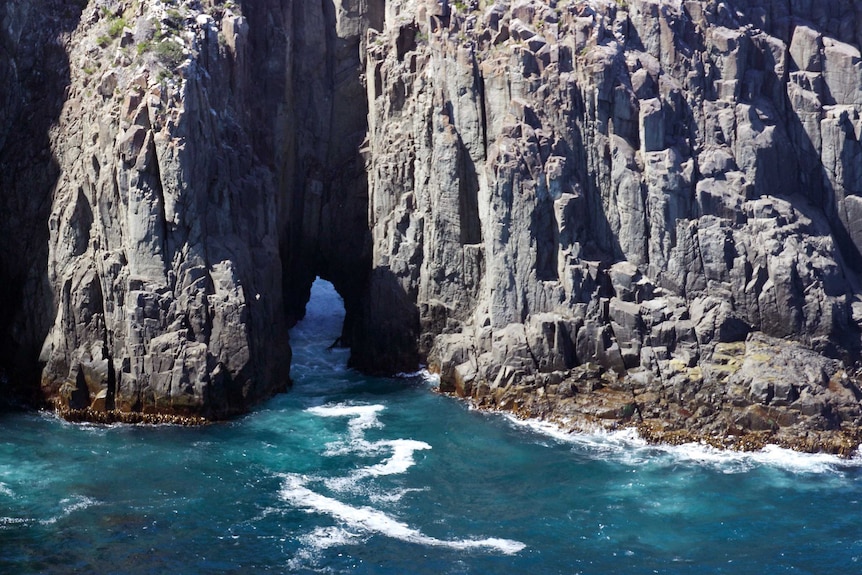 Undersea cave created in dolerite cliffs.