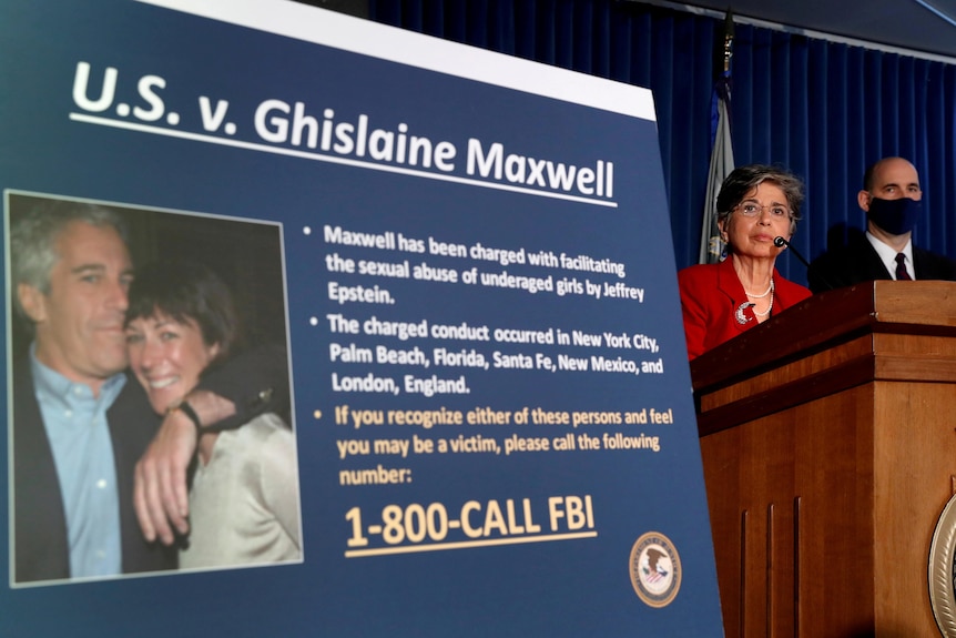 A New York official announces charges against Ghislaine Maxwell next to a poster of her and Epstein in this file photo from 2020