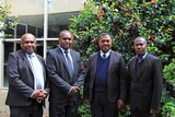 Four men in suits