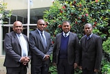 Four men in suits