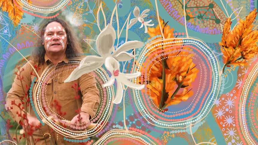 Clarence Slockee plays clap sticks and is surrounded by the artwork for the choir featuring stylised Australian flora.