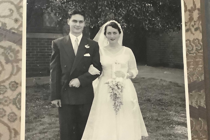 A black and white photo of a couple getting married