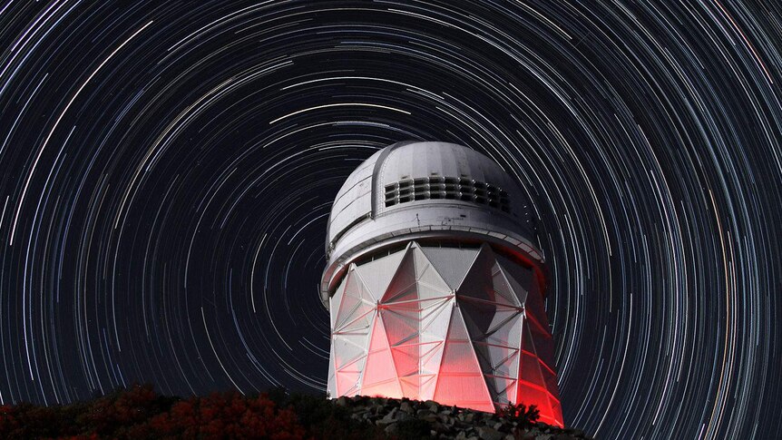 An observatory with star trails.
