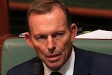 Tony Abbott sits in Parliament.
