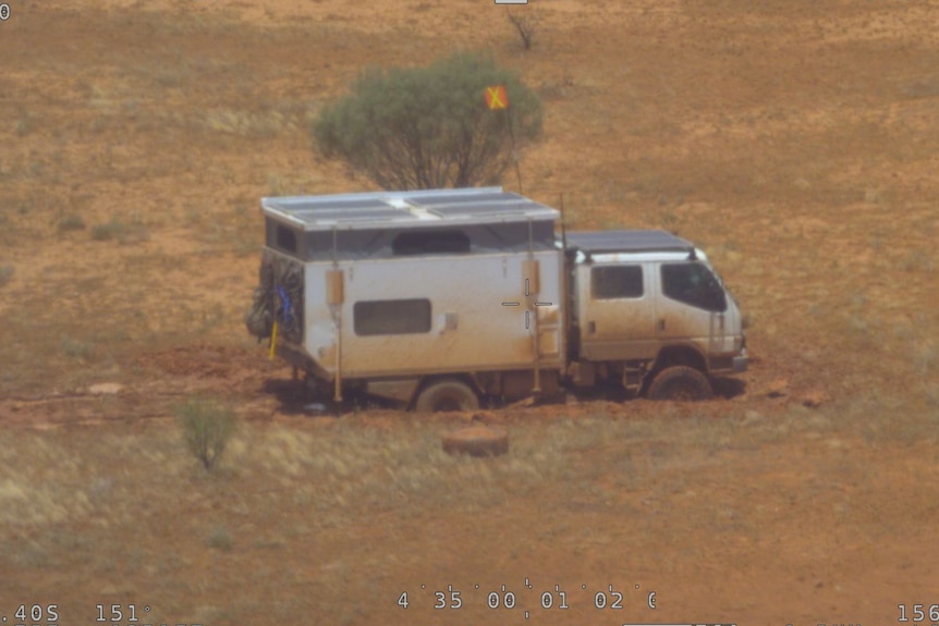 A four-wheel-drive campervan trapped by flooded roads.