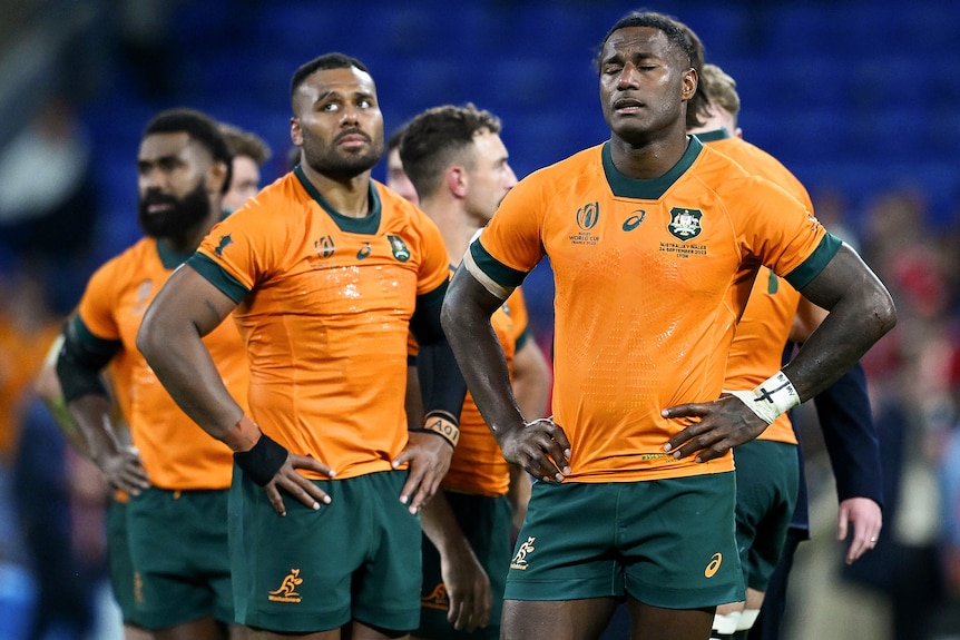 Wallabies players look disappointed after losing to Wales at Rugby World Cup.