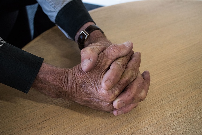 The hands of a man known as James who says he was abused at Marist College in Burnie