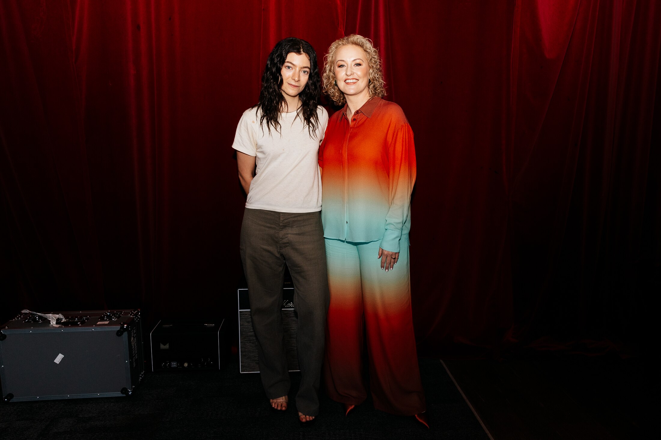 Lorde and Zan Rowe standing together arm in arm